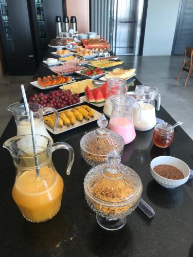 a buffet of food and drinks on a table at BALUARTE POUSADA in Torres