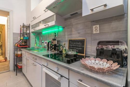 a kitchen with a counter top with a counter at Grey Orchid Apartment - studio in Budapest