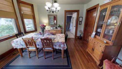 a dining room with a table with chairs and a chandelier at A Hidden Gem Bed and Breakfast in Windsor