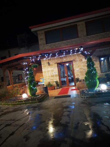 a building with christmas trees and lights in front of it at Agriturismo La Fattoria B&B in Limatola