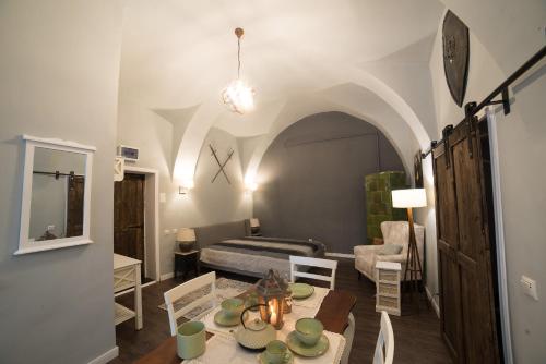 a living room with a table and a bedroom at Ultra central medieval apartment in Cluj-Napoca