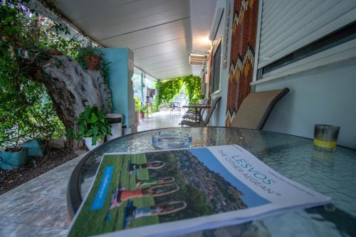 a book sitting on top of a glass table at Asmanis Rooms in Tarti
