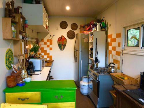 a kitchen with a green counter and a refrigerator at El refugio de budda in Sauce de Portezuelo