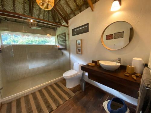 a bathroom with a shower and a sink and a toilet at Reserva Natural Tierra Adentro in Minca