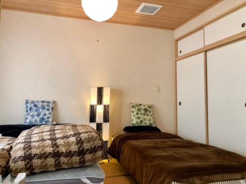 Ένα ή περισσότερα κρεβάτια σε δωμάτιο στο Midtown Sakura Apartment House 201 予約者だけの空間 A space just for you