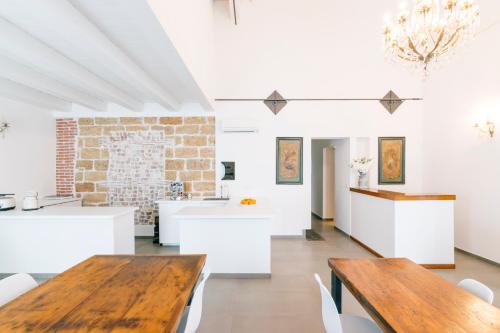 a dining room with white tables and a brick wall at Boutique BnB Dolcevita in Palermo