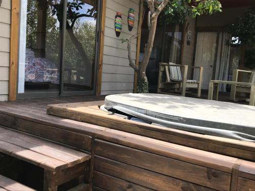 a bed on the front porch of a house at Cabañas La Luz in Olmué