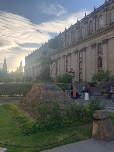a statue of a woman in front of a building at Hotel Occidental in Guadalajara