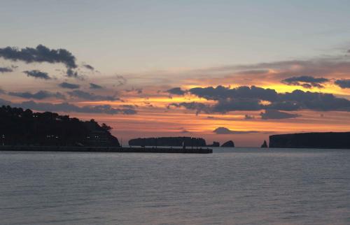 a sunset over a large body of water at Karalis City Hotel in Pylos