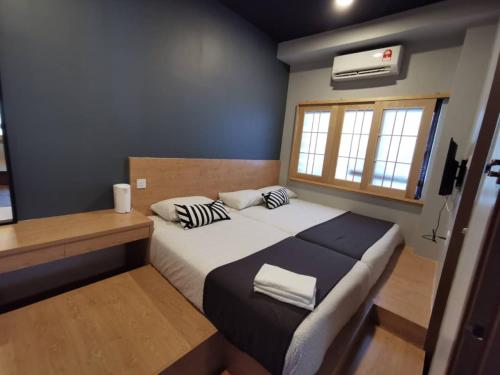 a small bedroom with a bed and a window at Tatami D'Tepi Laut - PANGKOR ISLAND in Pangkor