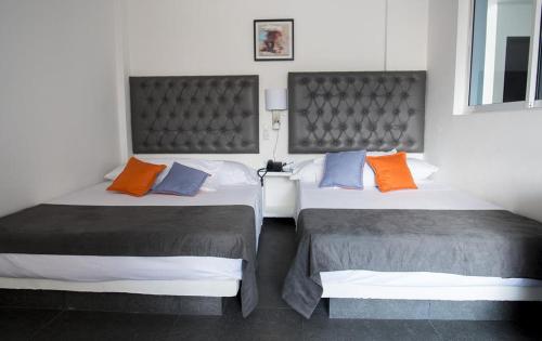 Postel nebo postele na pokoji v ubytování Hotel Grand H&R