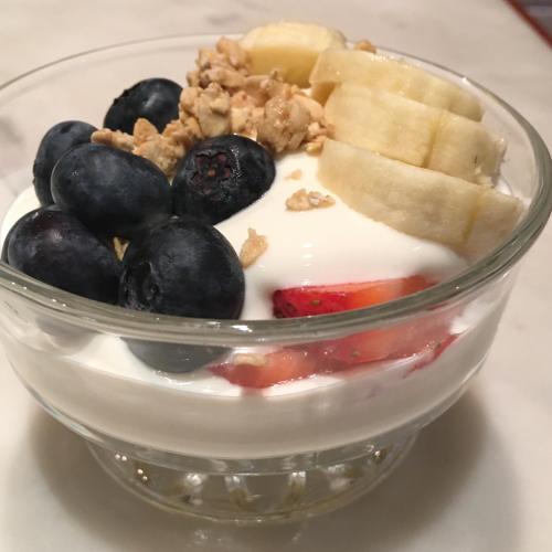 a bowl of fruit with yogurt and blueberries and nuts at Amante Luxury Bed & Breakfast in Victoria