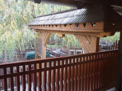 a wooden fence with a gazebo on a porch at Czermann Panzió és Étterem in Oroszlány