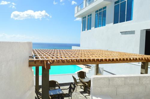 a patio with chairs and a view of the ocean at Residences Sommet Port Salut in Port-Salut