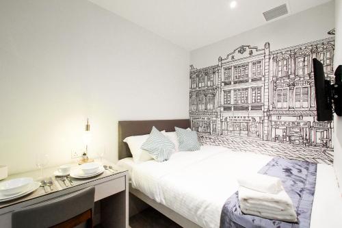 a bedroom with a bed with a black and white drawing on the wall at Heritage Collection on Chinatown - Mobile App Check-In in Singapore