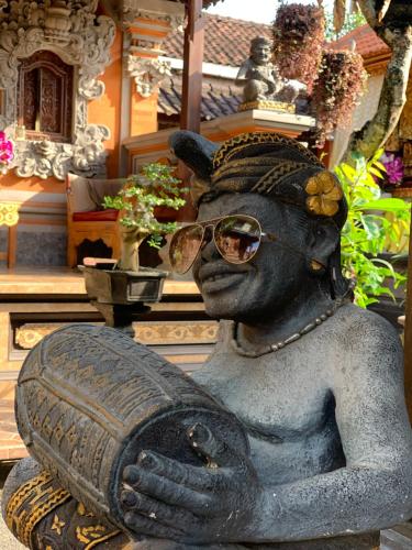a statue of a woman wearing sunglasses at Kukuh House Ubud in Ubud