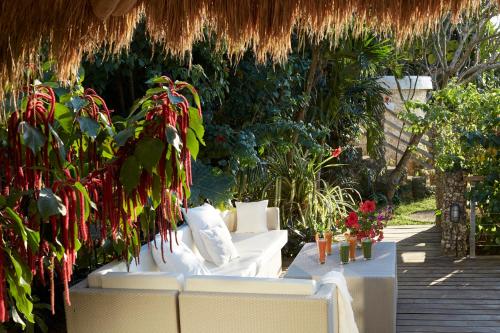 a patio with a white couch and some plants at Diniview Villa Resort in Boracay