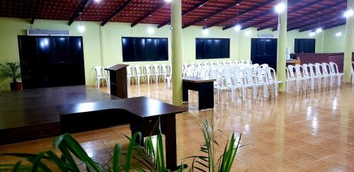 
a large room with a lot of chairs and tables at Pousada Brasil Cumbuco in Cumbuco
