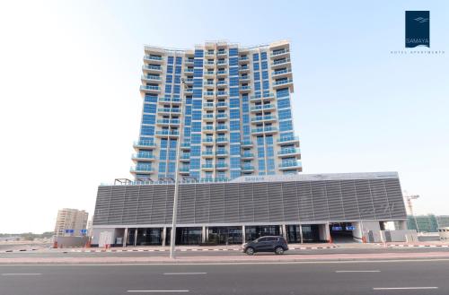 a car parked in front of a large building at Samaya Hotel Apartment Dubai in Dubai