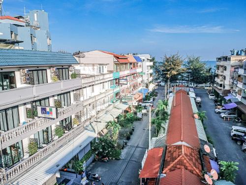 a city street with buildings and a train at THE BEACH CHA AM Guest House in Cha Am