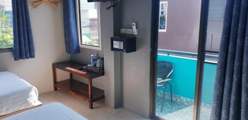 a room with a bed and a table and a swimming pool at Thapae Gate Lodge in Chiang Mai