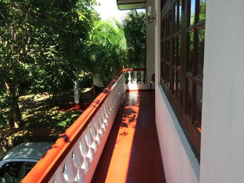 a balcony of a house with an orange railing at Galle Rest Home in Galle