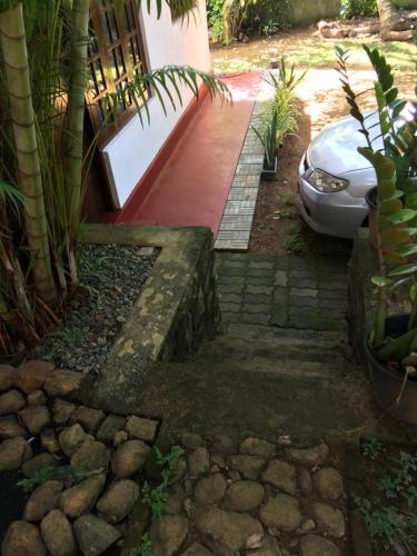 a driveway with a car parked next to a house at Galle Rest Home in Galle