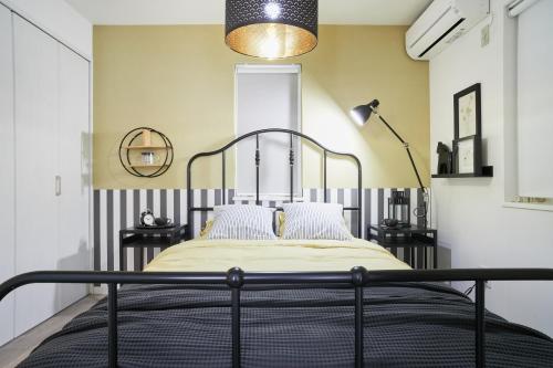 a bedroom with a bed with a black metal frame at Beautiful Villa in Shinjuku Shin-OKubo 6minutes walk B in Tokyo