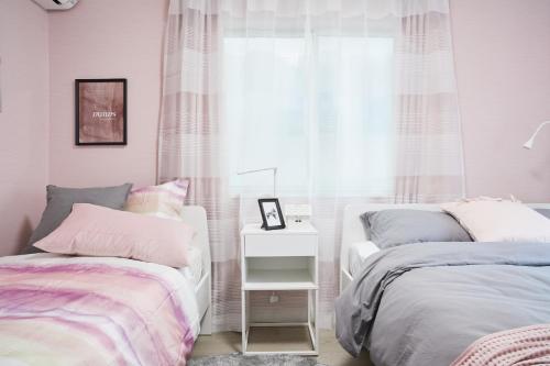 a bedroom with two beds and a window at Beautiful Villa in Shinjuku Shin-OKubo 6minutes walk B in Tokyo