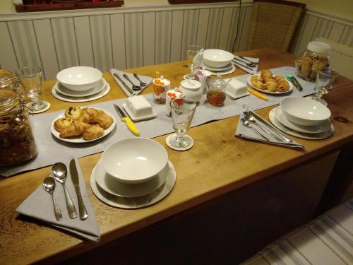 a table with white plates and silverware on it at Chine Side in Shanklin