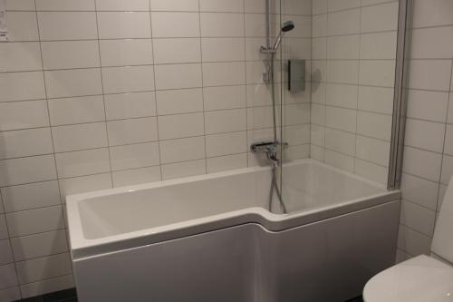a bath tub in a bathroom with a toilet at Best Western Hotel Corallen in Oskarshamn