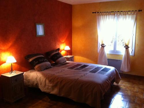 a bedroom with a large bed and a window at VILLA DU VERDON in Quinson