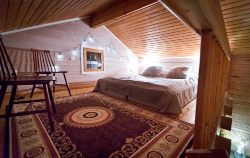 a bedroom with a bed in the middle of a room at Lake Kesänki Cottage in Äkäslompolo