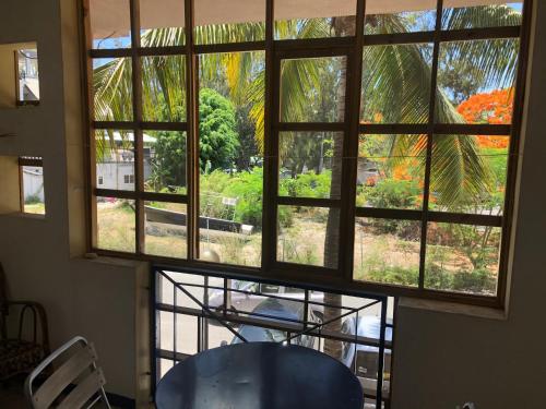 a view out of a window with a table and chairs at Dreamland apartment No3 in Grand Baie