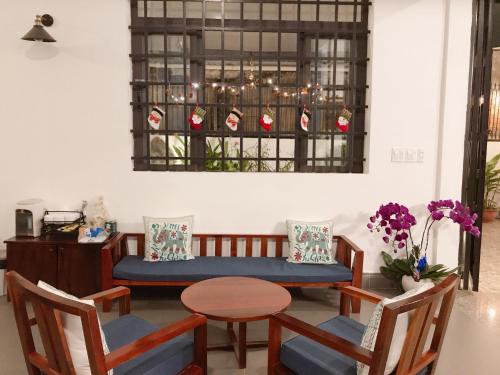 a room with a table and chairs and a window at Queenie House in Can Tho