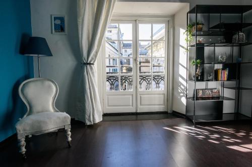 a living room with a chair and a window at B&B Piccoli Leoni in Genova