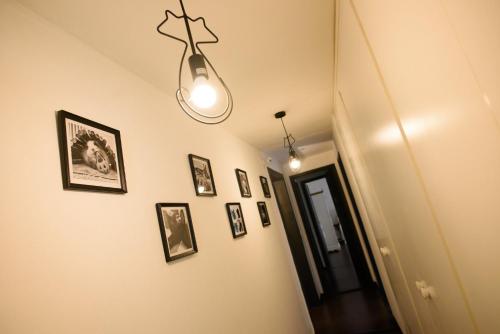 a hallway with framed pictures on a wall at B&B Piccoli Leoni in Genova