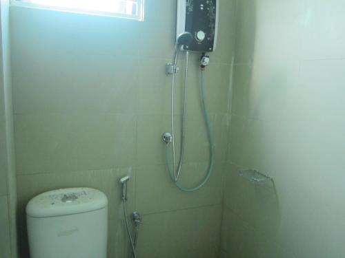 a small bathroom with a shower and a toilet at WeJDAN INN BALIK PULAU, PENANG ISLAND in Balik Pulau
