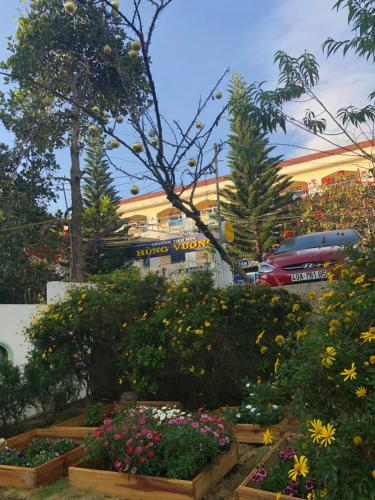 a garden of flowers in front of a building at Thu Linh Guesthouse in Da Lat