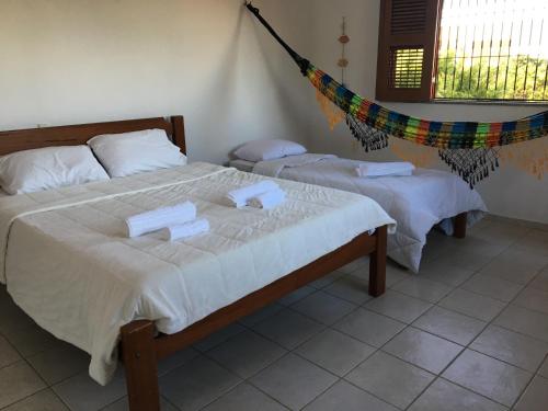 A bed or beds in a room at Beach House Paracuru B&B - cama e café