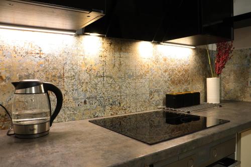 a kitchen counter with a coffee maker on a counter top at Dom pod Magurką in Wilkowice