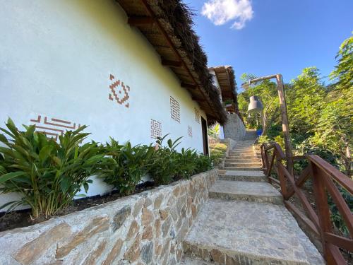 a building with stairs and plants on the side of it at Reserva Natural Tierra Adentro in Minca
