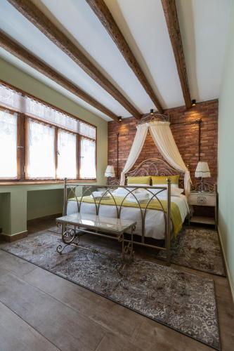 a bedroom with a bed with a canopy at MARIA'S BOUTIQUE Rooms in Kórinthos