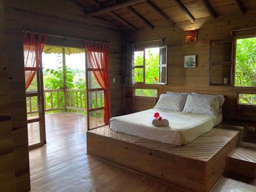 a bedroom with a bed in a room with windows at Soul Fire Casitas in Montezuma