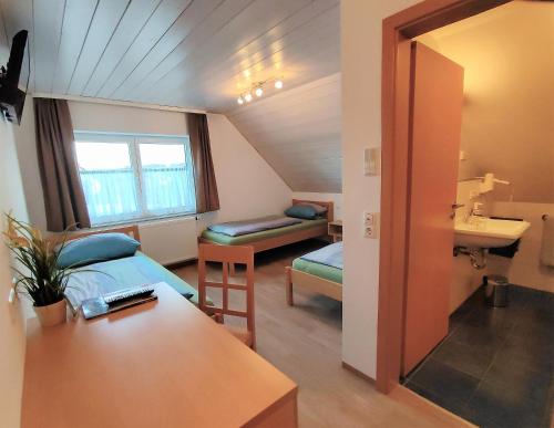 a room with a bed and a sink in a room at BodenSEE Haus am Geissbock in Meckenbeuren