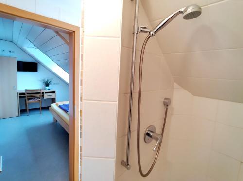 a shower with a shower head in a bathroom at BodenSEE Haus am Geissbock in Meckenbeuren