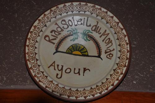 a plate with a sign that says volleyballamineamine your at Riad Soleil du Monde in Zagora