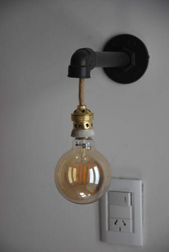 a light hanging from a wall next to a lightswitch at Sur Hotel in Necochea