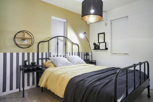 a bedroom with a black and white bed and a mirror at Beautiful Villa in Shinjuku Shin-OKubo 6minutes walk B in Tokyo