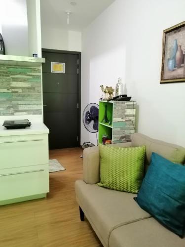 a living room with a couch and a dresser at ACQUA Private Residences 1BR Condo in the heart of downtown Makati & Mandaluyong in Manila